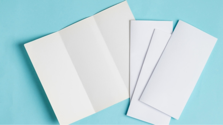 Qué-es-un-brochure Brochures en blanco sobre una superficie azul.