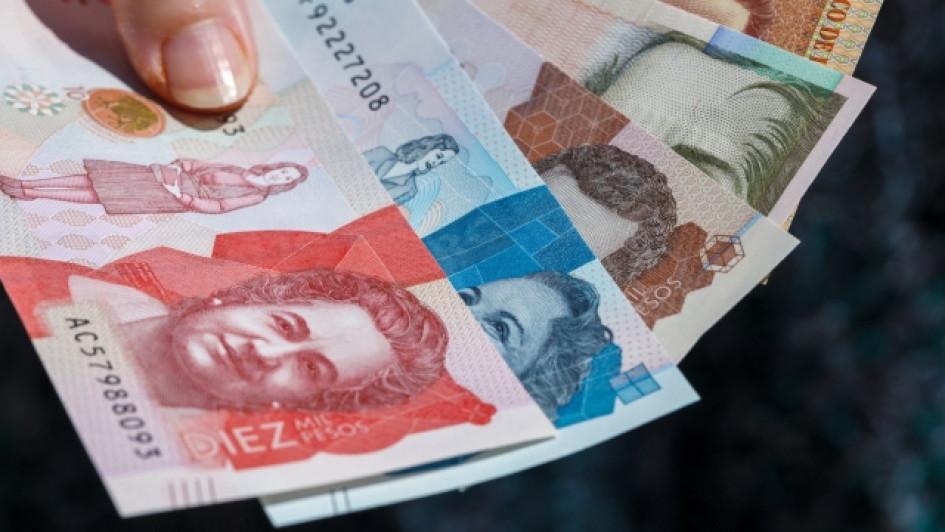 Cuando-pagar-IVA Mano sosteniendo varios billetes de pesos colombianos